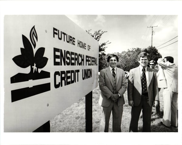 two men standing near construction sign